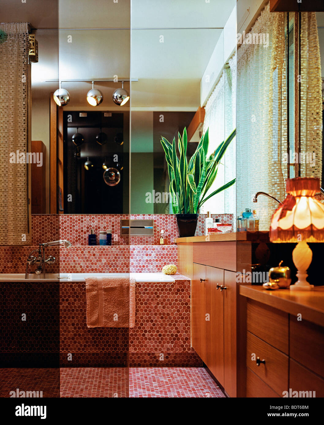 1970s Bathroom with red tiling and glass wall France Europe Stock Photo ...