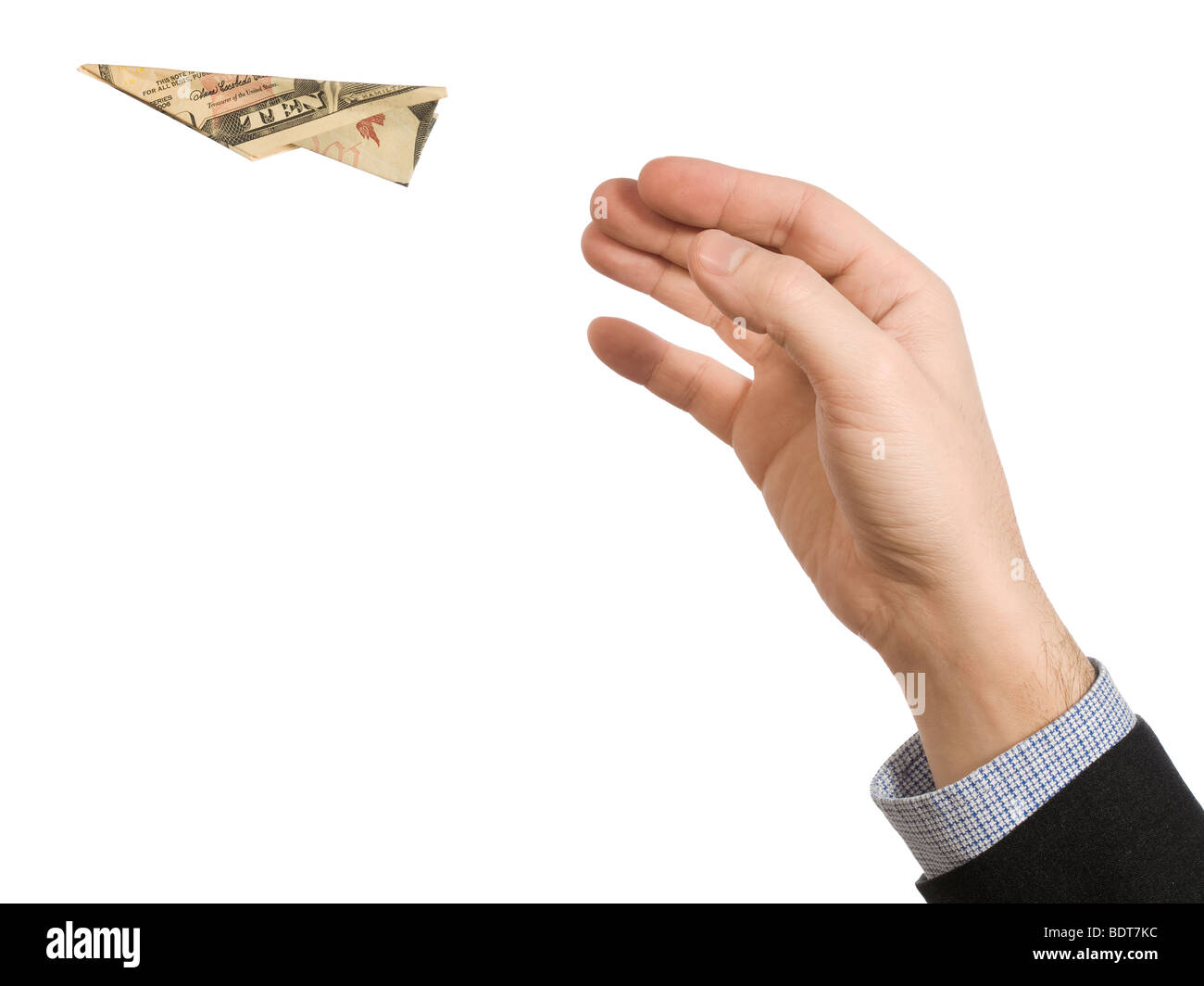 A man's hand throwing a paper plane made of a ten dollar bill. Stock Photo