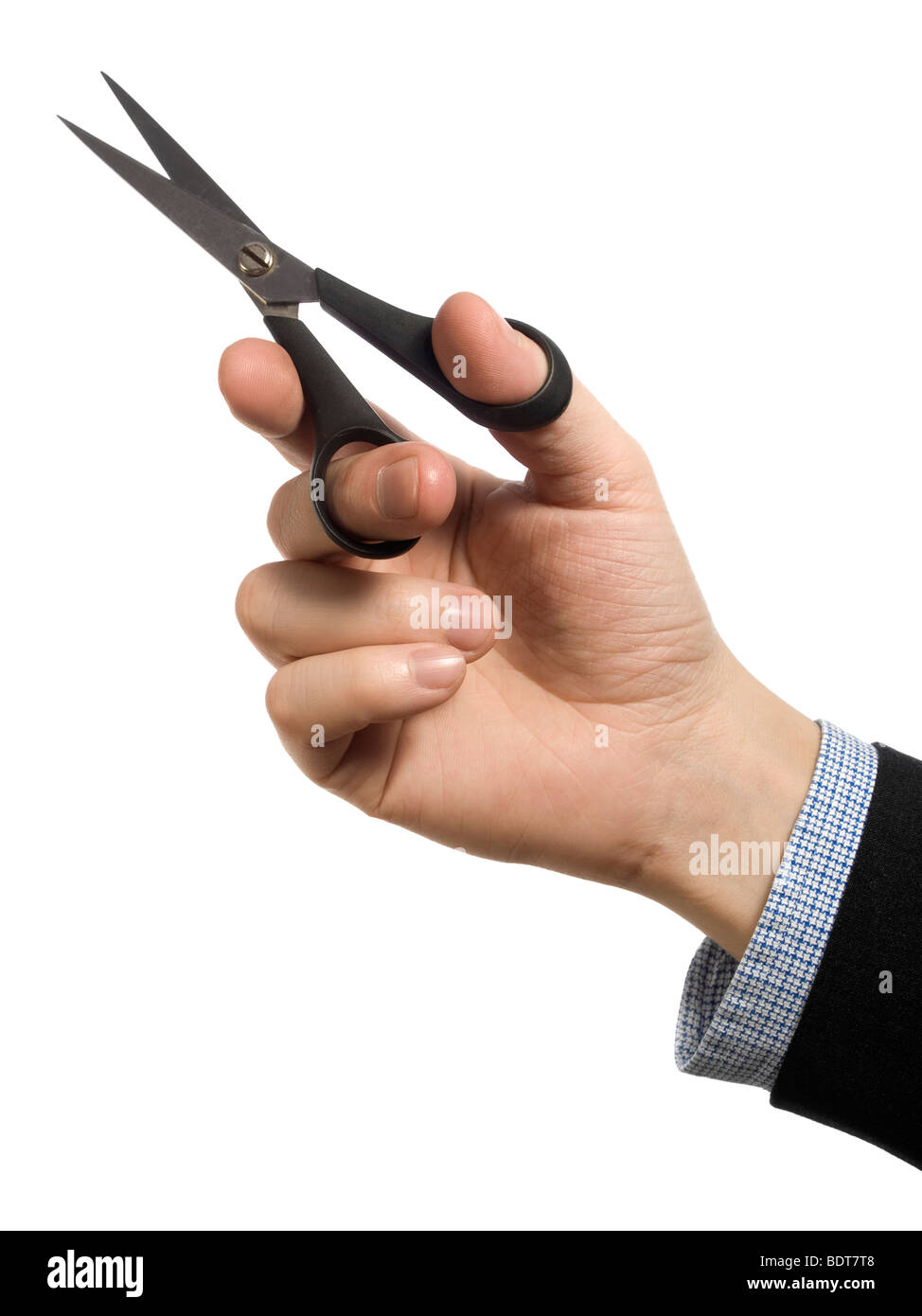 A man's hand holding a pair of scissors over a white background. Stock Photo