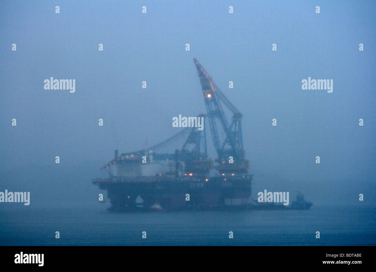 Oil or gas rig in the evening mist off Stavanger Stock Photo