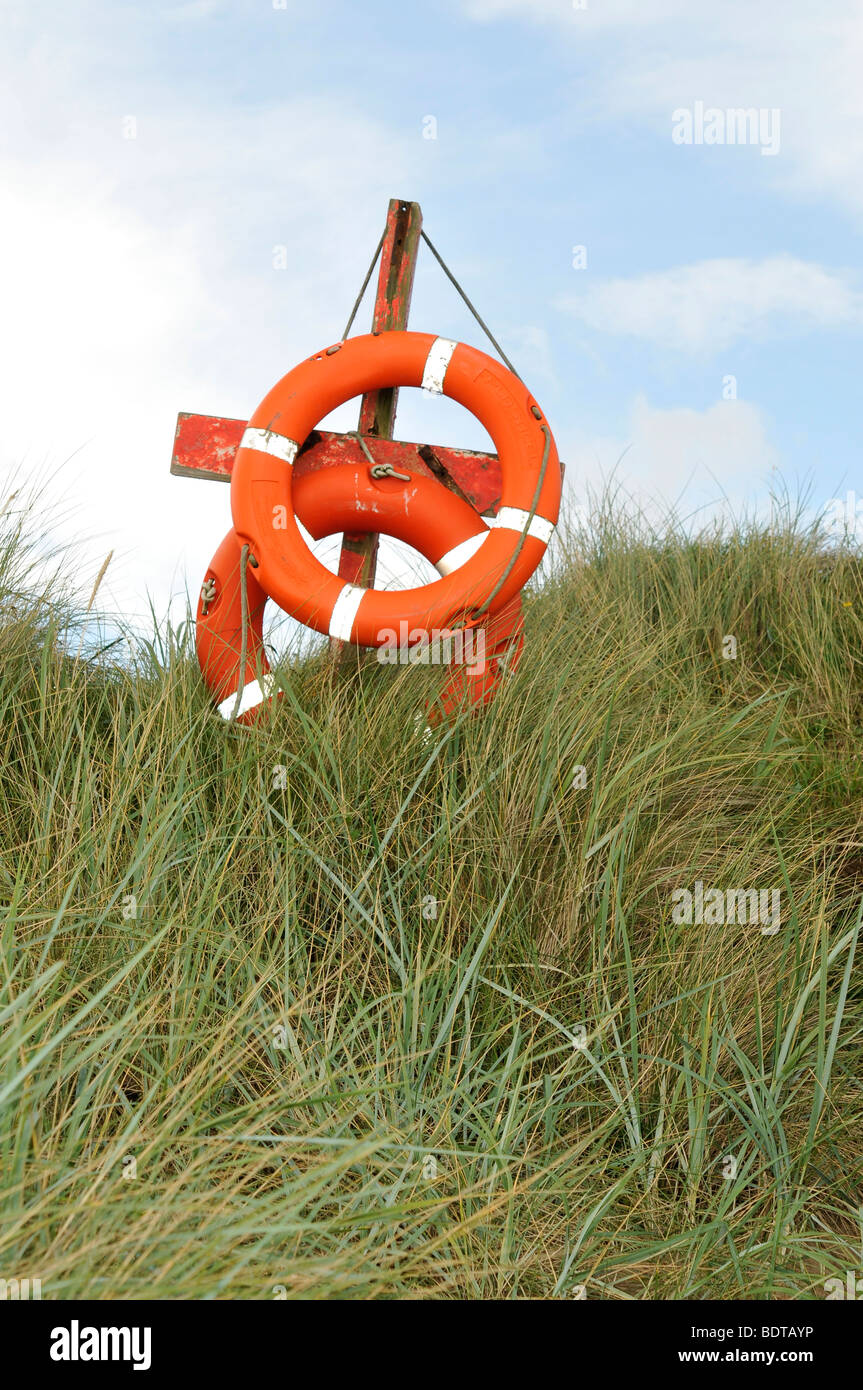 life saver bouy aid rescue swimming coast swimming bathing seaside danger Stock Photo
