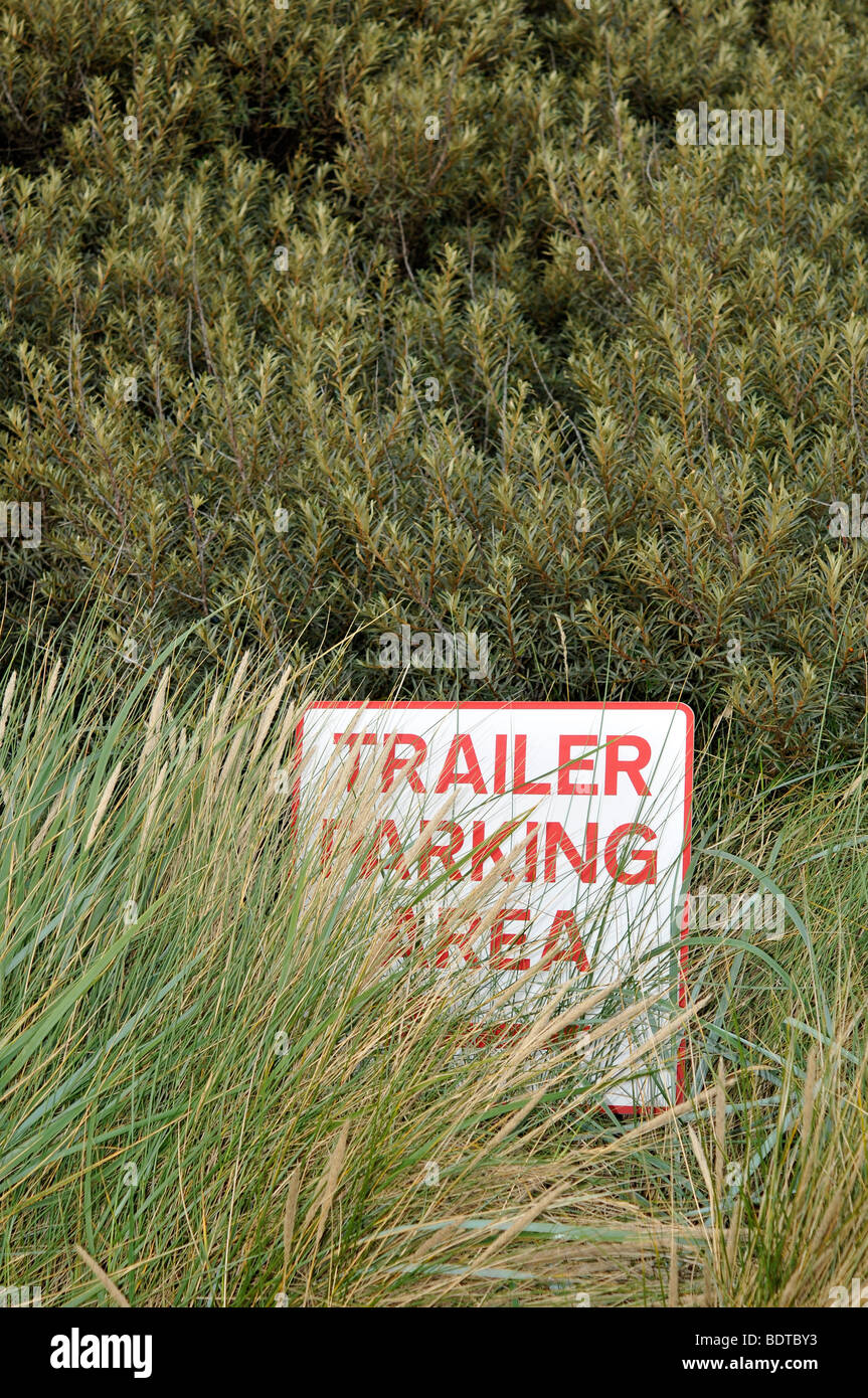 trailer parking sign  beadnell harbour northumberland seaside coast dunes sand overgrown Stock Photo