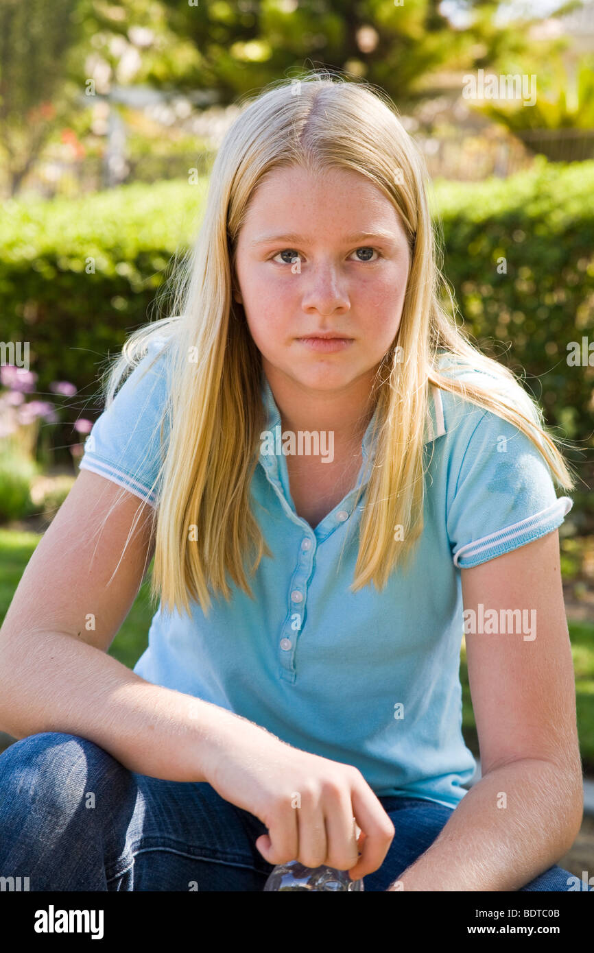 Junior high age girl 11-13 year years old meditating reflecting thinking serious thoughts thoughtful dreaming sitting MR  © Myrleen Pearson Stock Photo