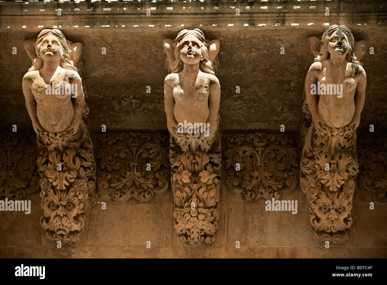 Sculptured Baroque balcony supports -  Palazzo Nicolaci  - Noto - Sicily Stock Photo