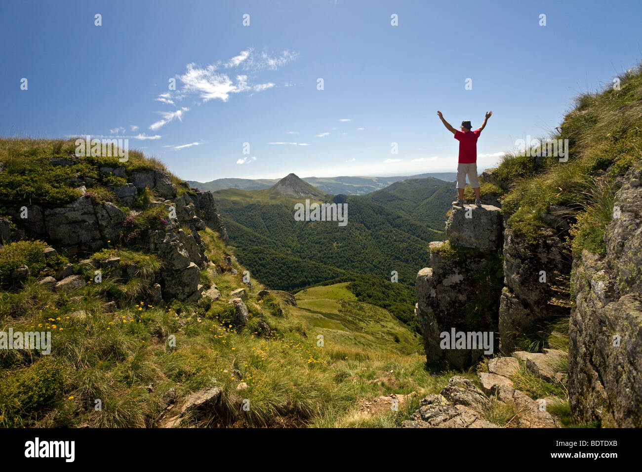 A hiker in the Mounts of Cantal (Auvergne - France). Randonneur dans les Monts du Cantal (Auvergne - France). Stock Photo