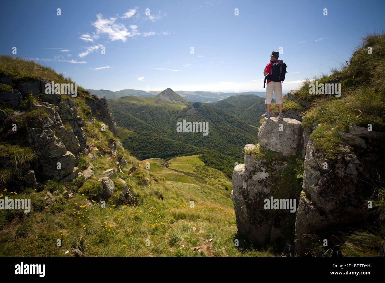 A hiker in the Mounts of Cantal (Auvergne - France). Randonneur dans les Monts du Cantal (Auvergne - France). Stock Photo