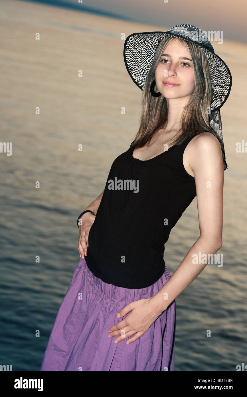 Portrait of a young woman by the sunset Stock Photo - Alamy