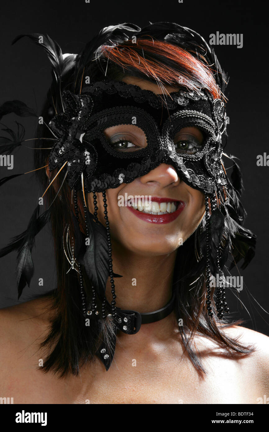 Sexy Burlesque Girl Wearing a Black Feather Carnival Mask Stock Photo