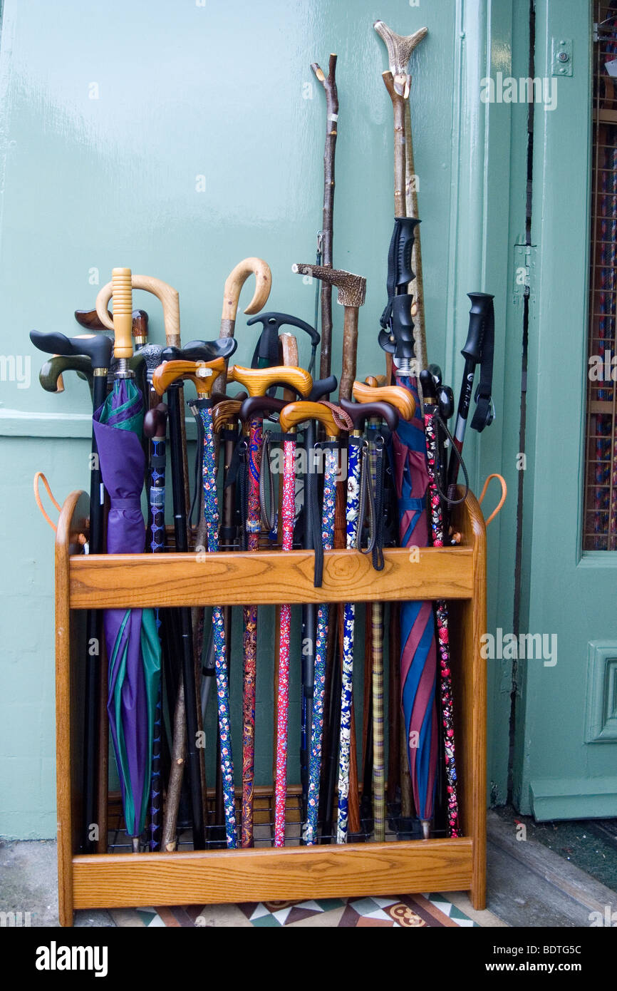 Colourful walking sticks and umbrellas on display outside a shop Stock Photo