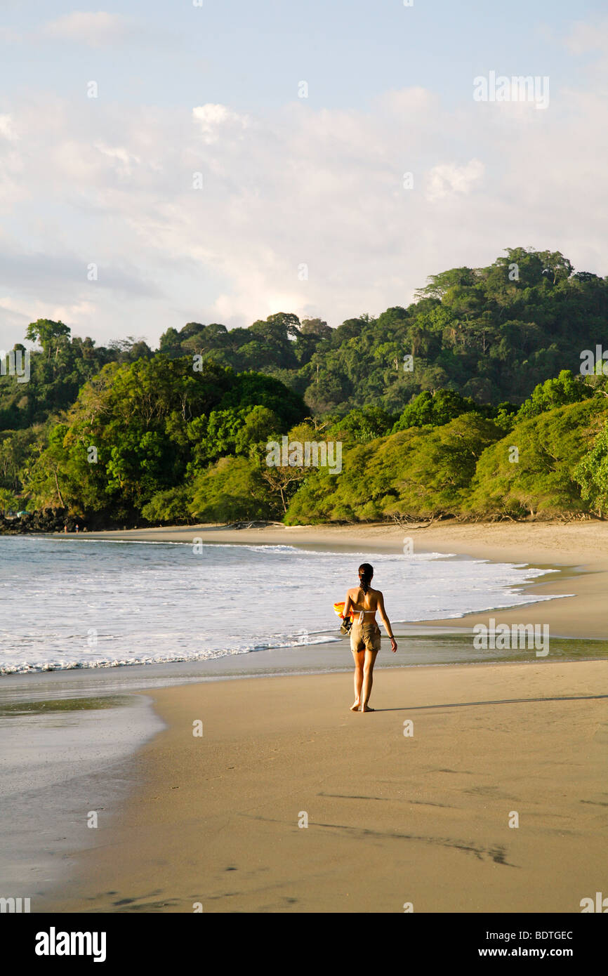costa rica central latin america quepos manuel antonio national park woman walking along the beach in the afternoon Stock Photo