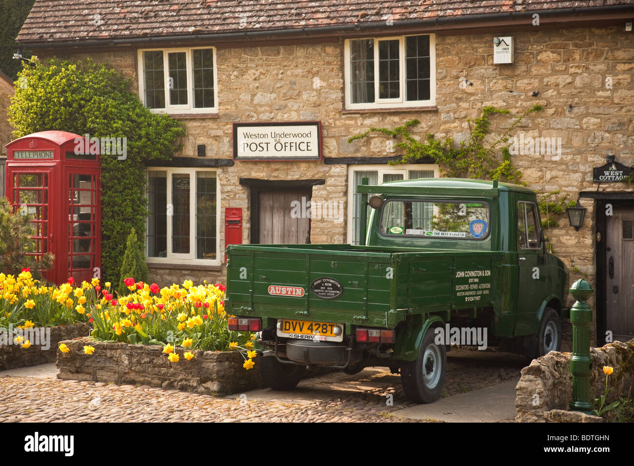 Old English county post office in the village of Weston Underwood with post box, telephone booth and old van Stock Photo