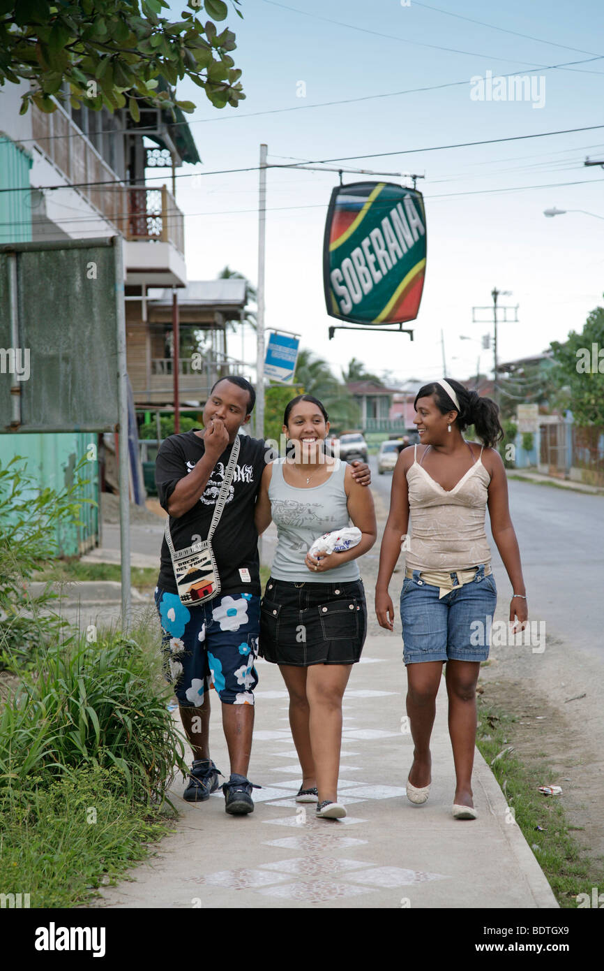 panama, bocas del toro, young happy smiling people walking on side walk in bocas town Stock Photo