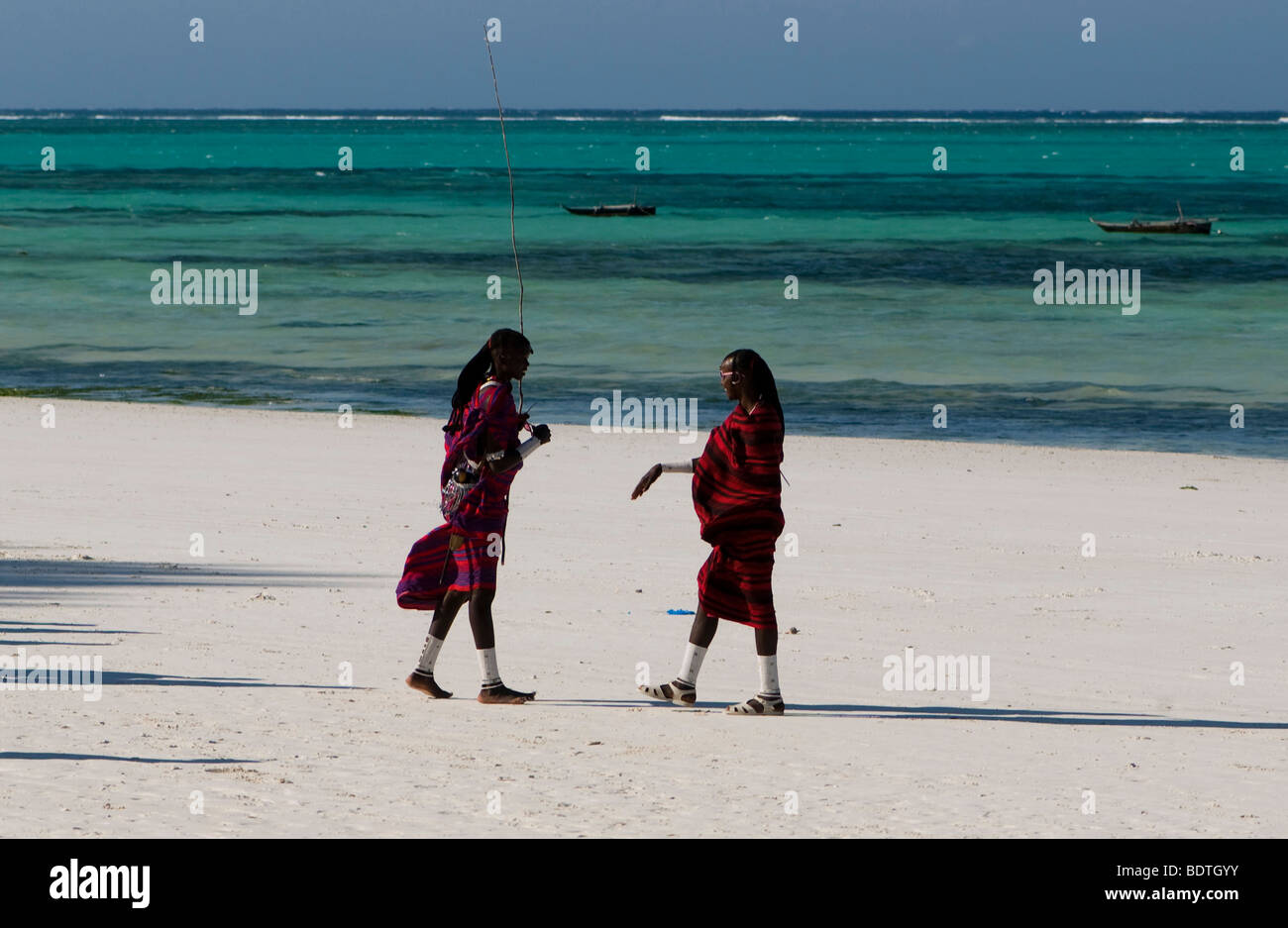 Two masai warrior walking on the beach Stock Photo