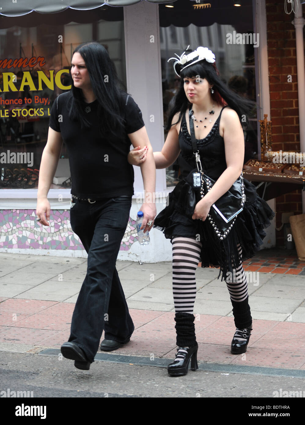 Couple wearing goth style fashion walking through Brighton on August Bank Holiday Stock Photo