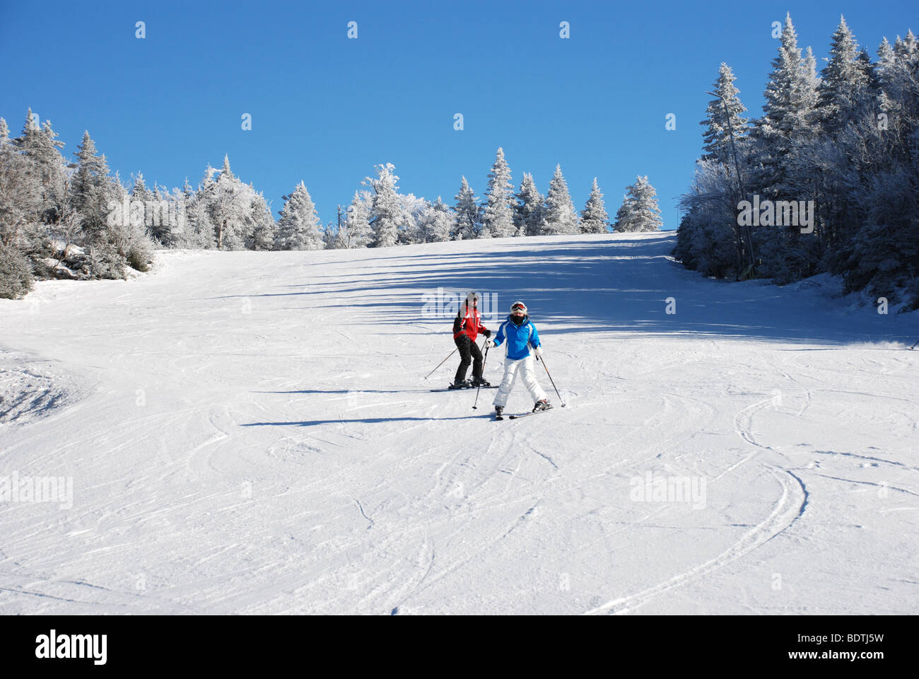 Beginners skiing downhill Stock Photo