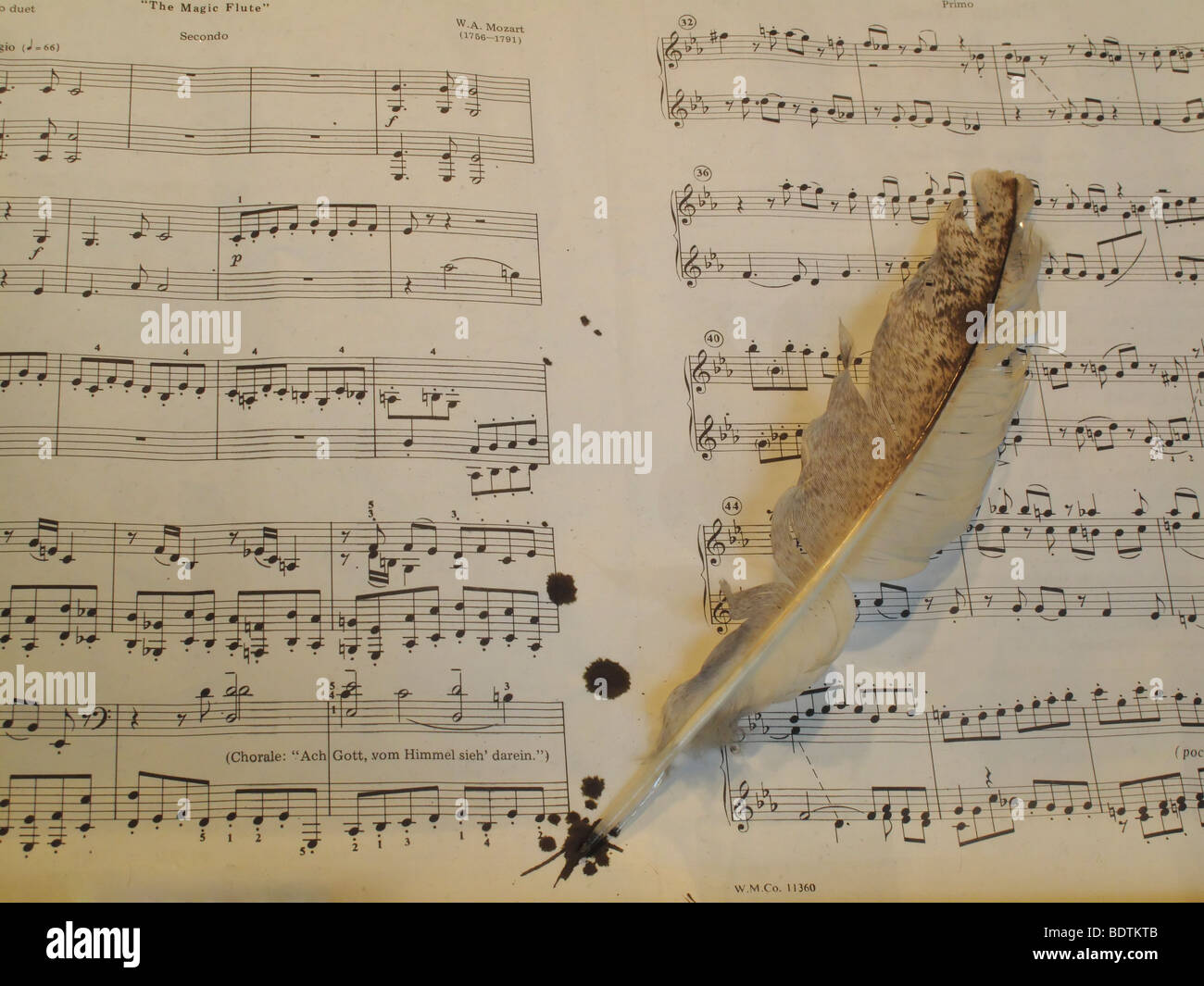 Vintage writing quill pen with written musical notation manuscript Stock Photo