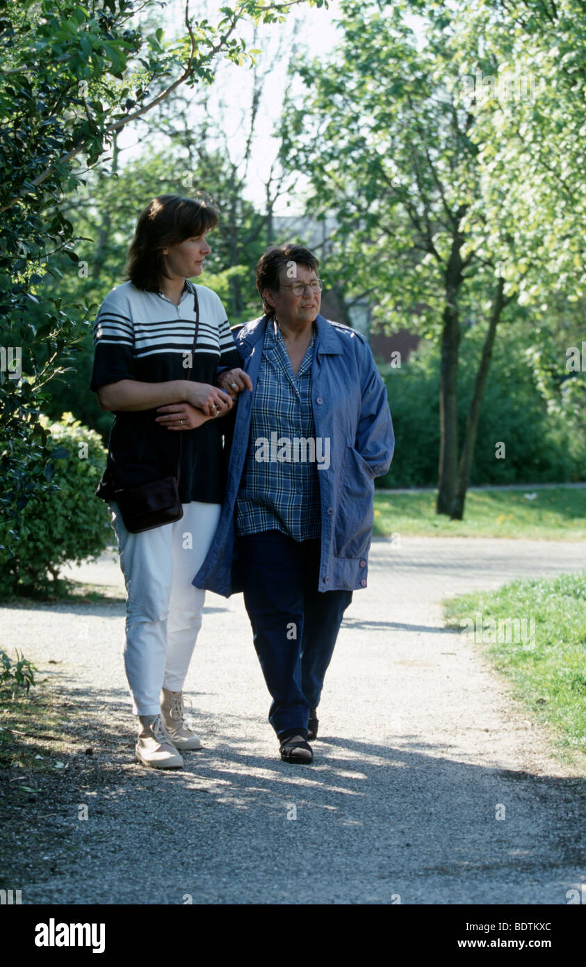 Carer helping senior woman walk hi-res stock photography and images - Alamy