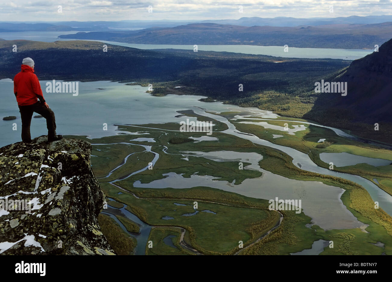 wanderer outdoor view from Mount Skierffe to the Rapadelta and the lake laitaure, lapland, sweden Stock Photo