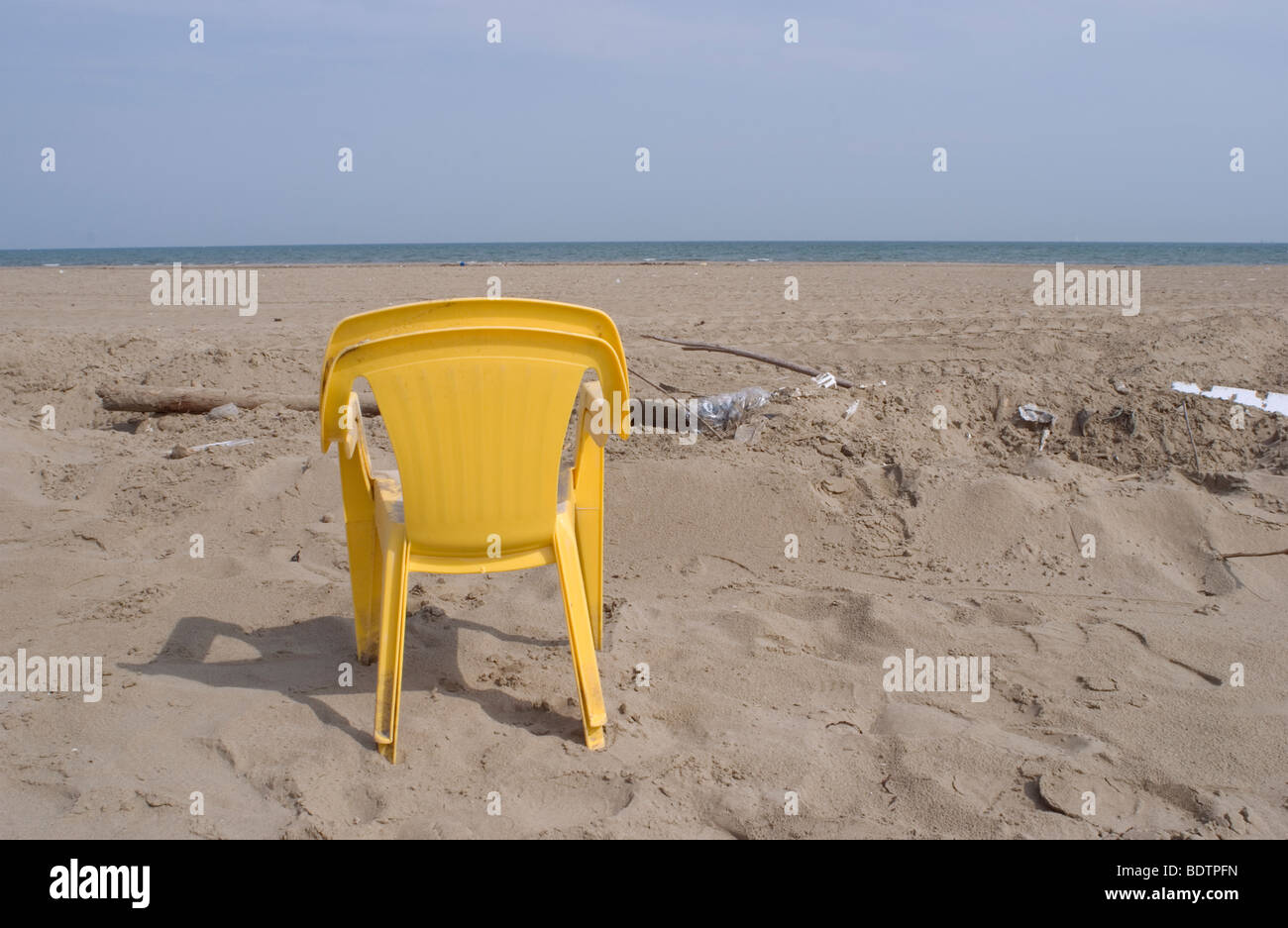 plastic chairs dumped on beach Stock Photo - Alamy