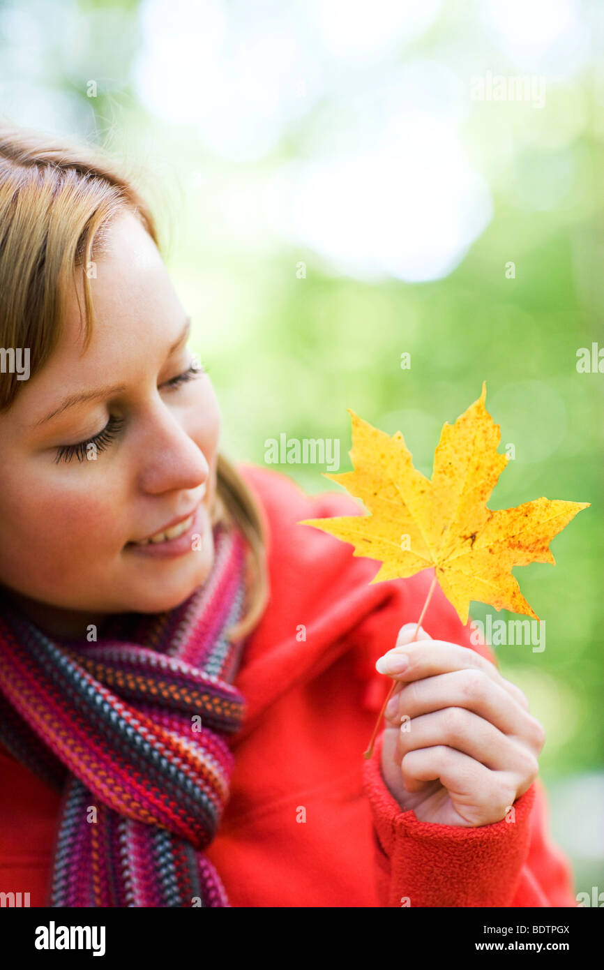 Portrait of a woman holding a maple leaf hi-res stock photography and ...