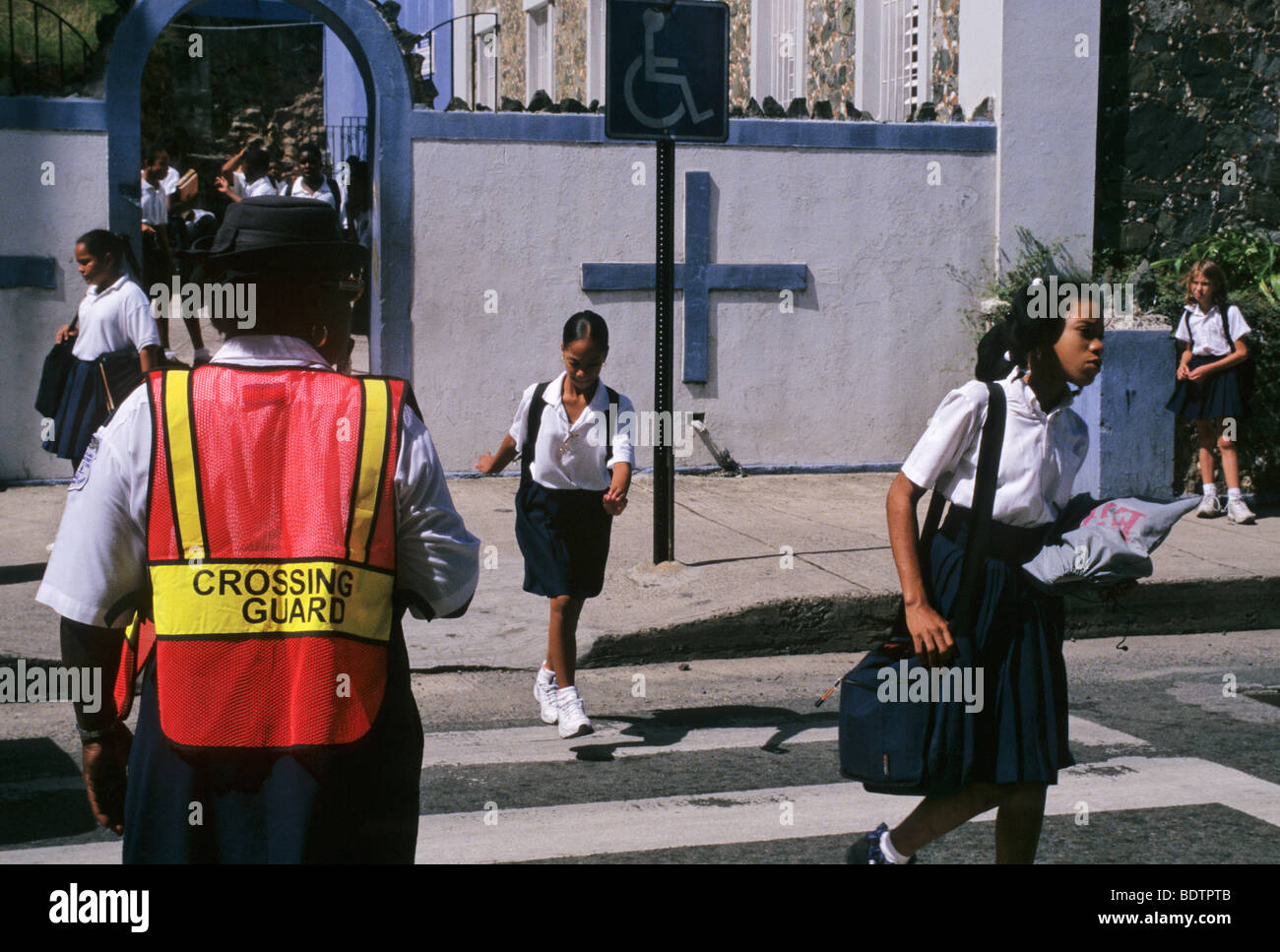 school girls and crossing guard outside a christian school - Charlotte Amalie - St Thomas - Virgin Islands Stock Photo