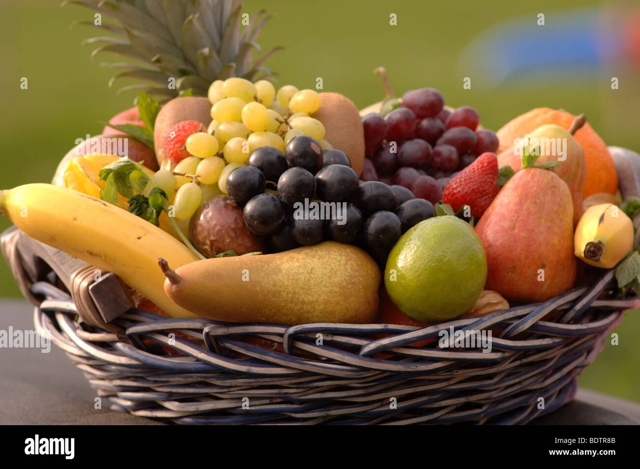 fruits, orange, strawberry, melone, bananas, grapes, vitamins wicker basket Stock Photo