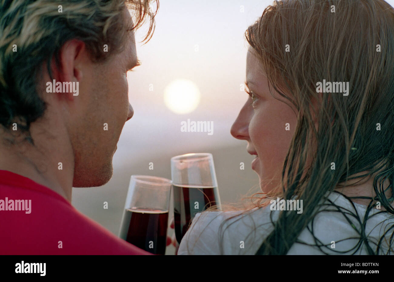 romantic couple with goblet of red wine on a beach Stock Photo - Alamy