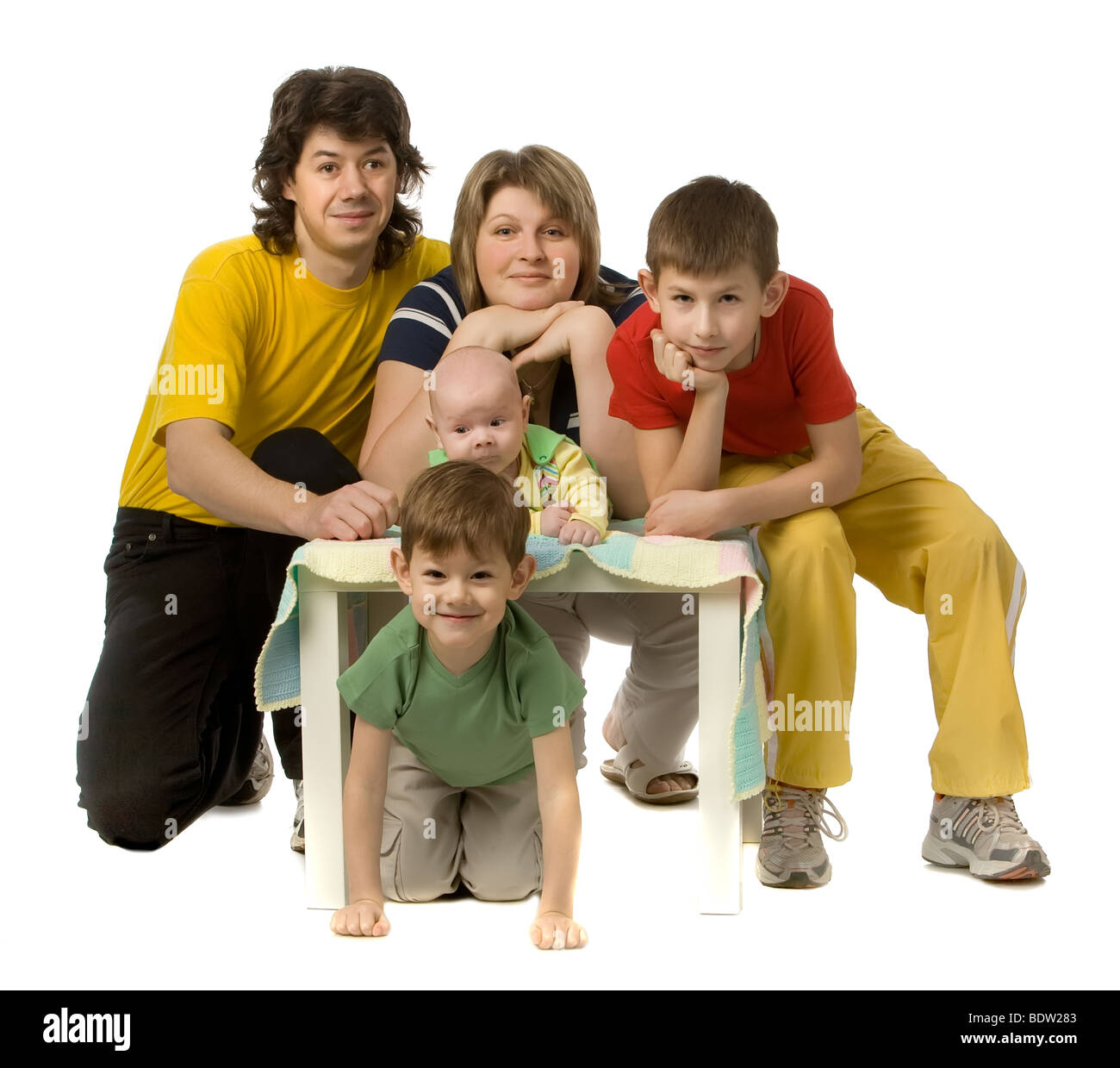 Happy family with three children in colour clothes, isolated on white Stock Photo
