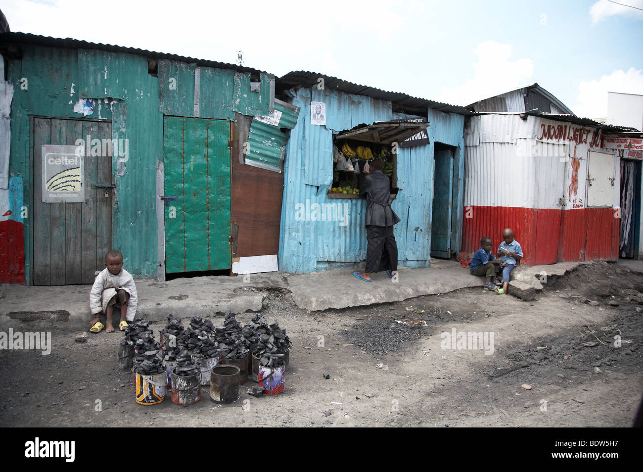 KENYA Small shop and child selling charcoal (for cooking), Mukuru Ruben