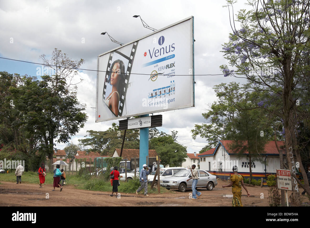 KENYA Advertising billboard and pedestrians, Nairobi. Photo by Sean