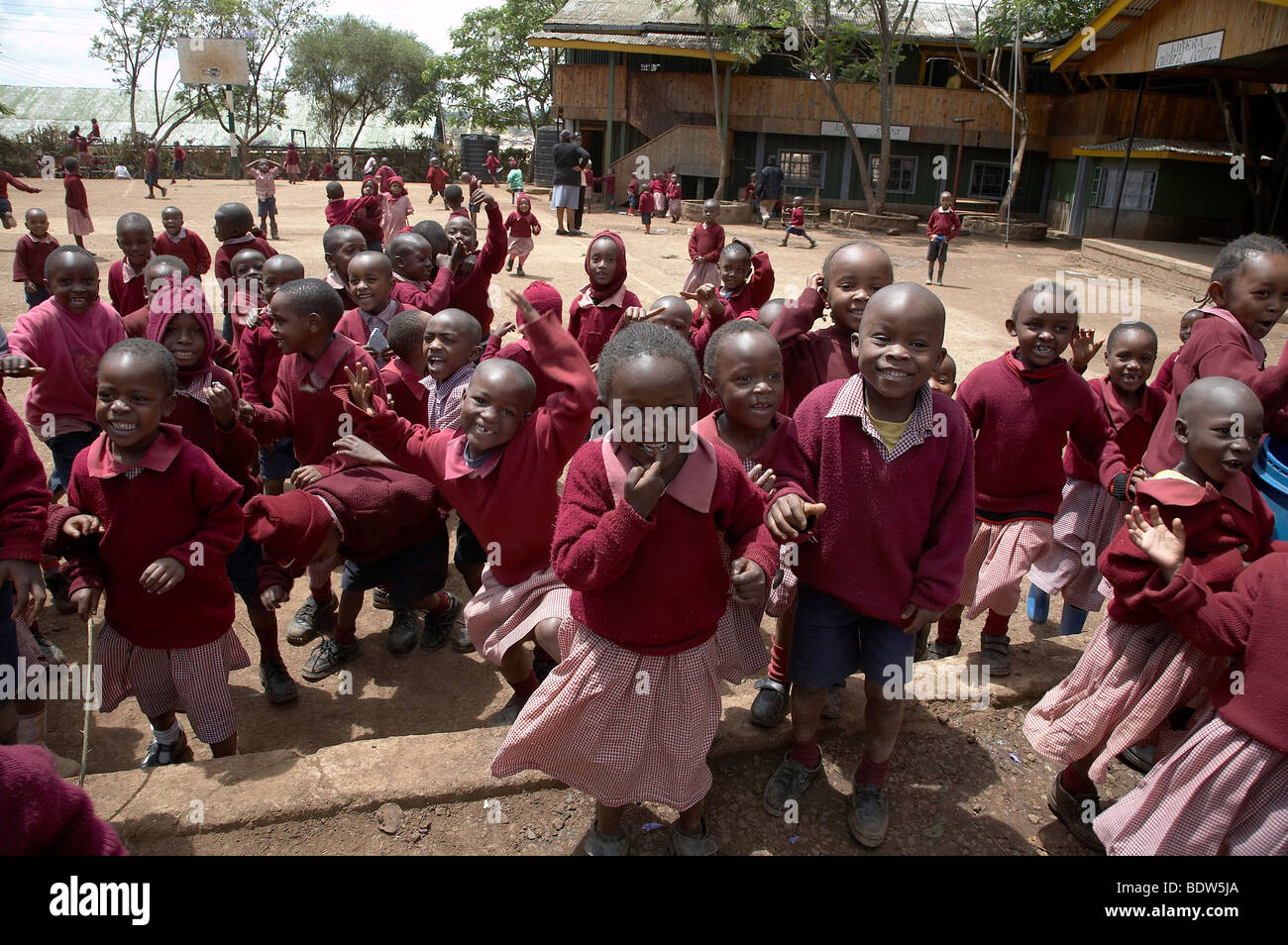 KENYA Children in school uniforms playing in the yard of Christ the King Catholic school, Kibera, a slum of Nairobi. Stock Photo