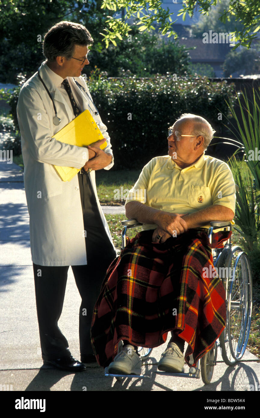 Doctor with Wheelchair Bound Patient Stock Photo