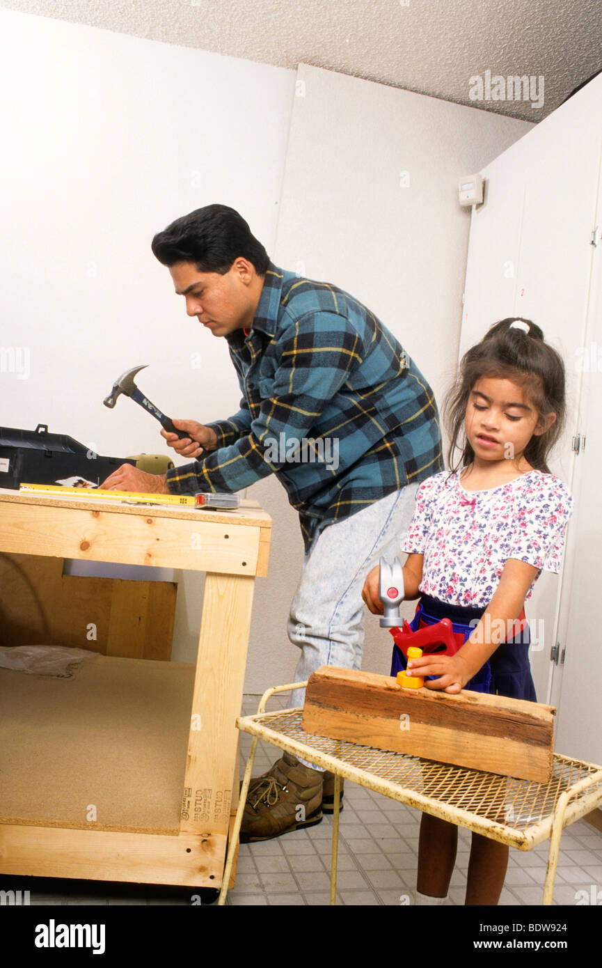 Latin girl copies father example duplicate parent child learn Stock Photo Alamy