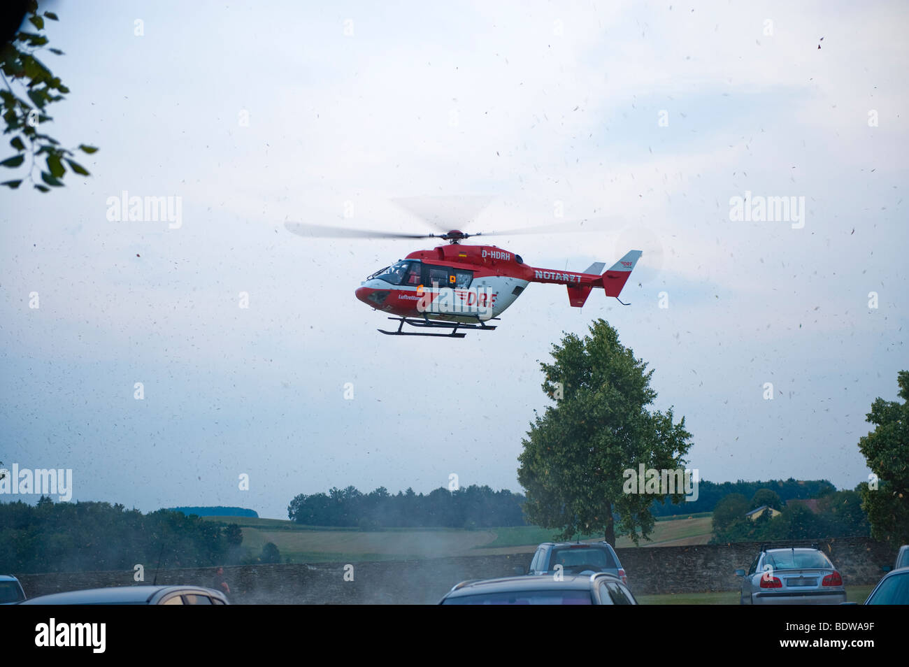 red rescue helicopter emergency doctor physician response rescue life saver lifesaver fly flying flight landing action ar parkin Stock Photo