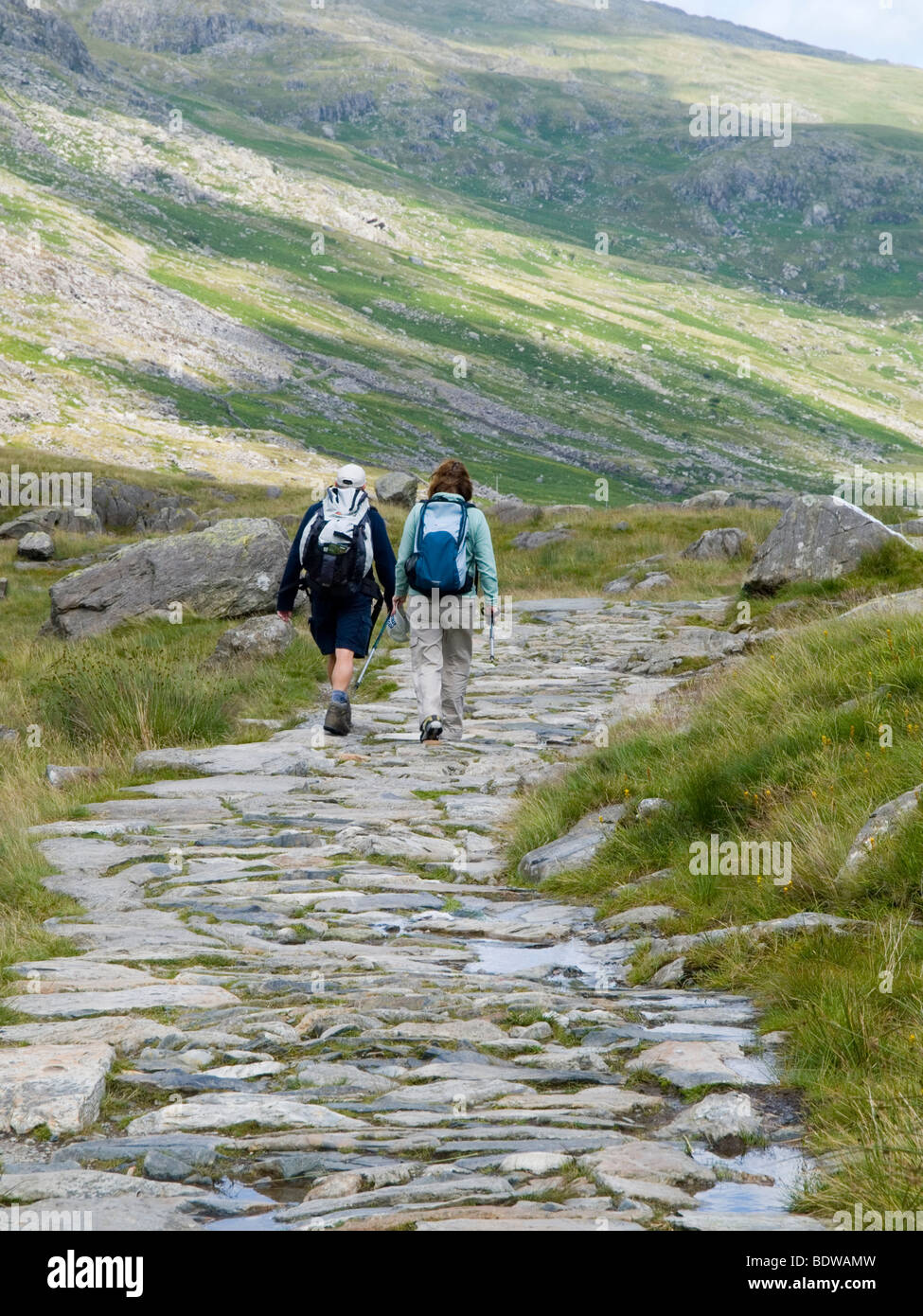 Two walkers on a path in the Glyders by Tryfan, Snowdonia Wales UK Stock Photo