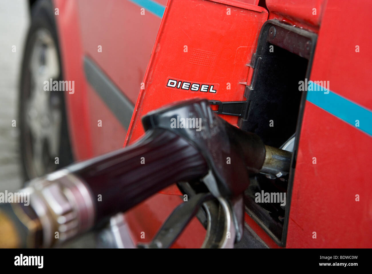 Close up of red car filling with petrol, Norway Stock Photo