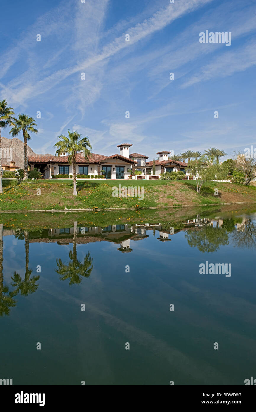 Vertical view across lake of large luxury home Stock Photo