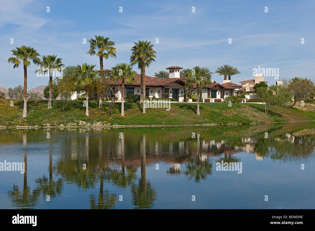 Large home overlooking a lake on golf course Stock Photo