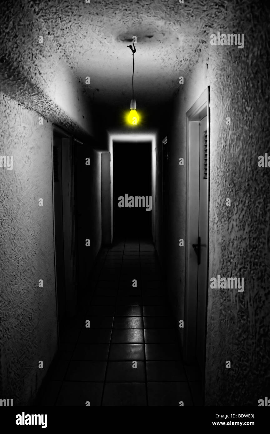 Yellow light glowing in dark underground corridor. Stock Photo