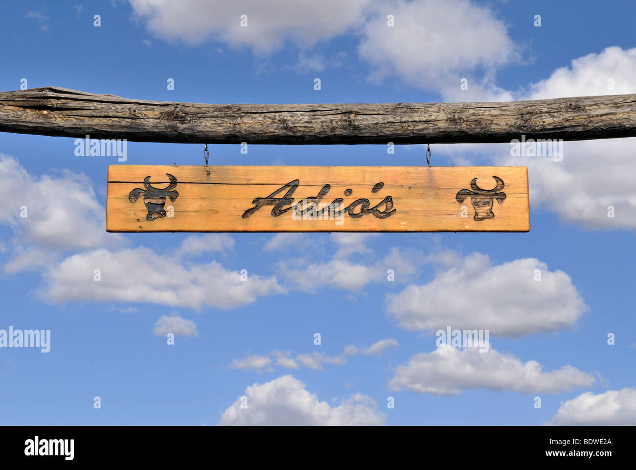 Sign, 'Adios', farewell, above the entrance to a farm, Tucson, Arizona, USA Stock Photo