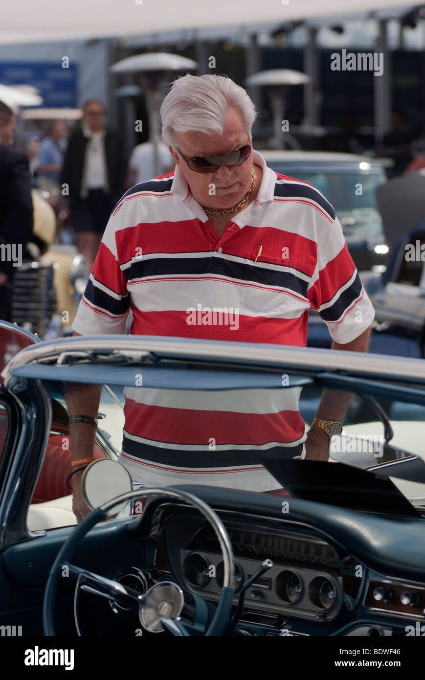 Bidder looking at a 1960 Pontiac Convertible before the Gooding & Company auction during the Pebble Beach Concours d'Elegance Stock Photo