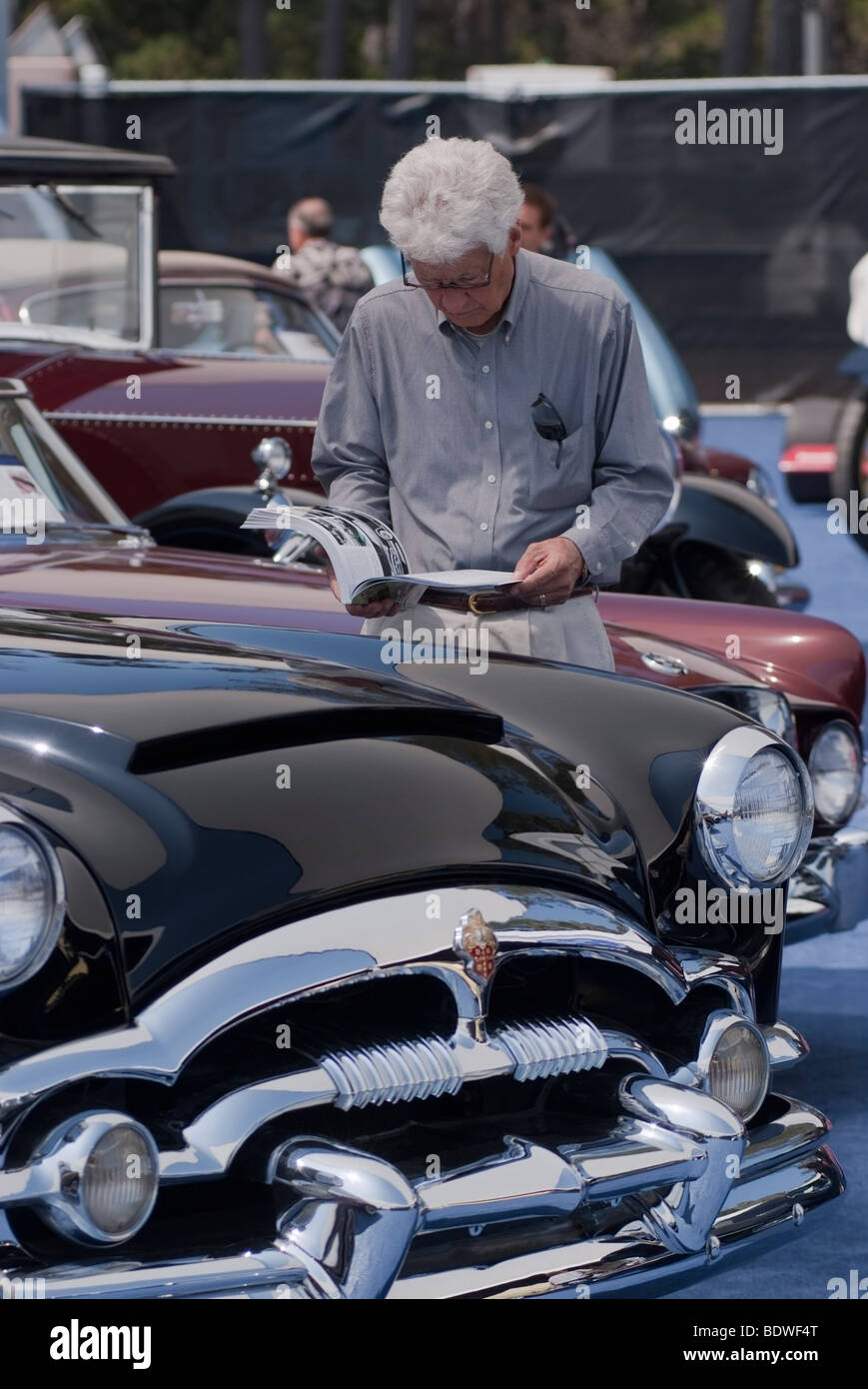 Bidder inspecting a 1953 Packard Caribbean before the Gooding & Company auction during the Concours d'Elegance in Pebble Beach Stock Photo