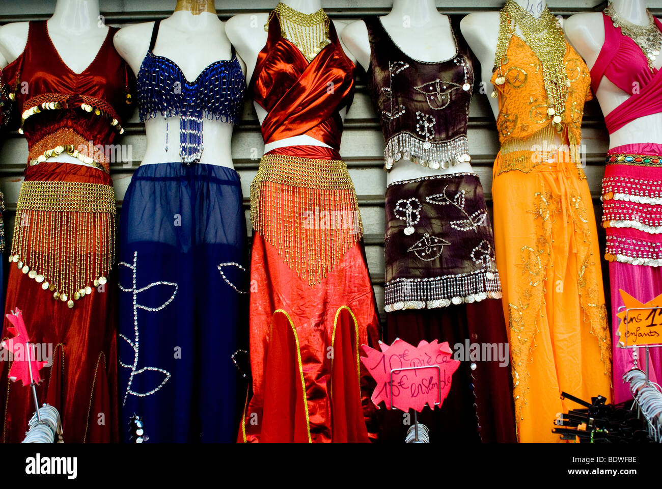 colourful belly dancing costumes for sale hanging in the Street market