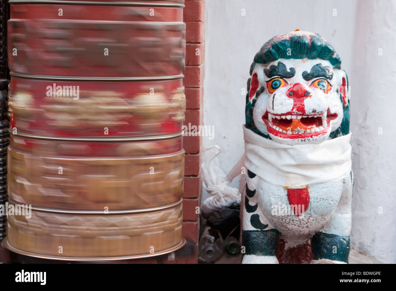 Bodhnath, Nepal. Mythical Snow Leopard Guarding Entrance to Buddhist Shrine, Prayer Wheel