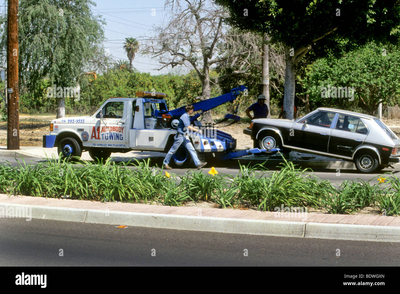 local auto shops service stations mechanics auto club contract outfits use smaller tow vehicles Stock Photo