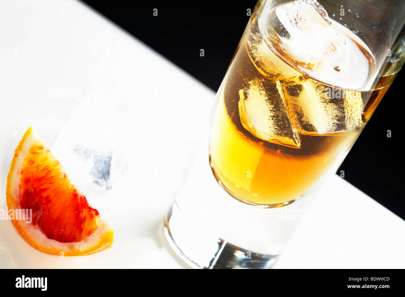 Iced, orange long drink with a slice of blood orange Stock Photo