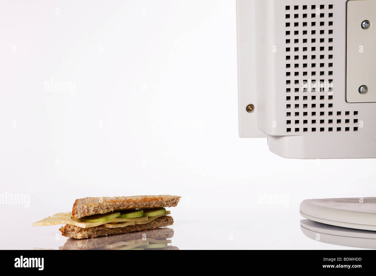 Sandwich at the computer of a working station Stock Photo