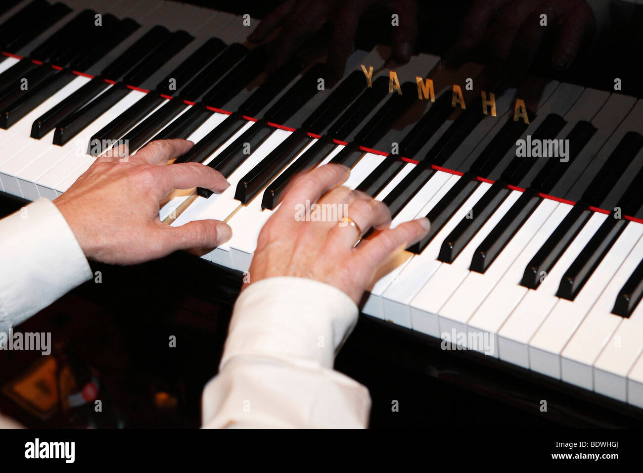 Hands playing the piano Stock Photo