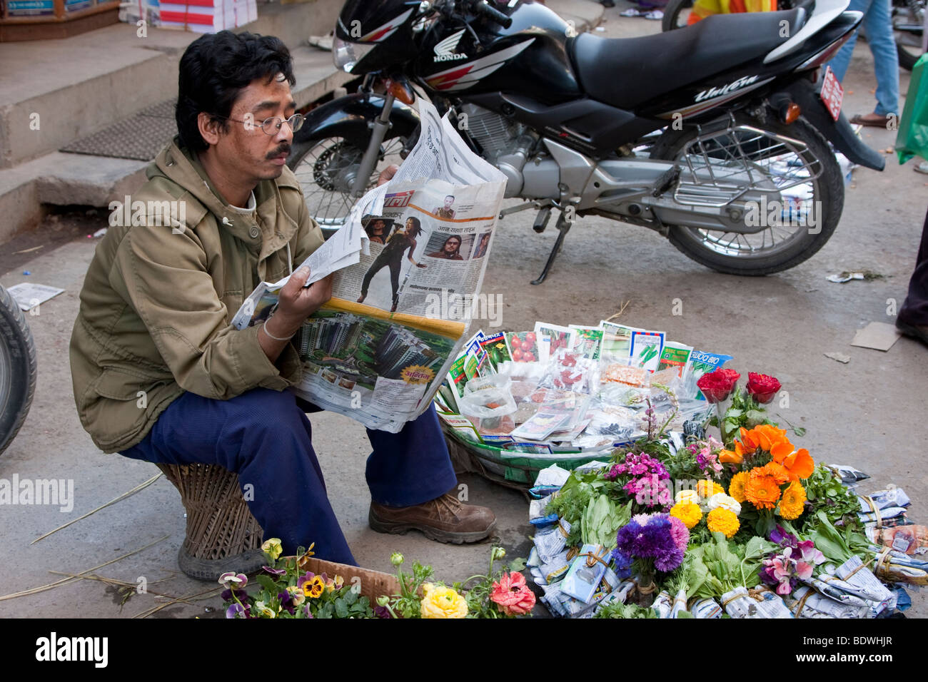 Kathmandu, Nepal. Nepali Vendor of Flowers and Flower Seeds Reading