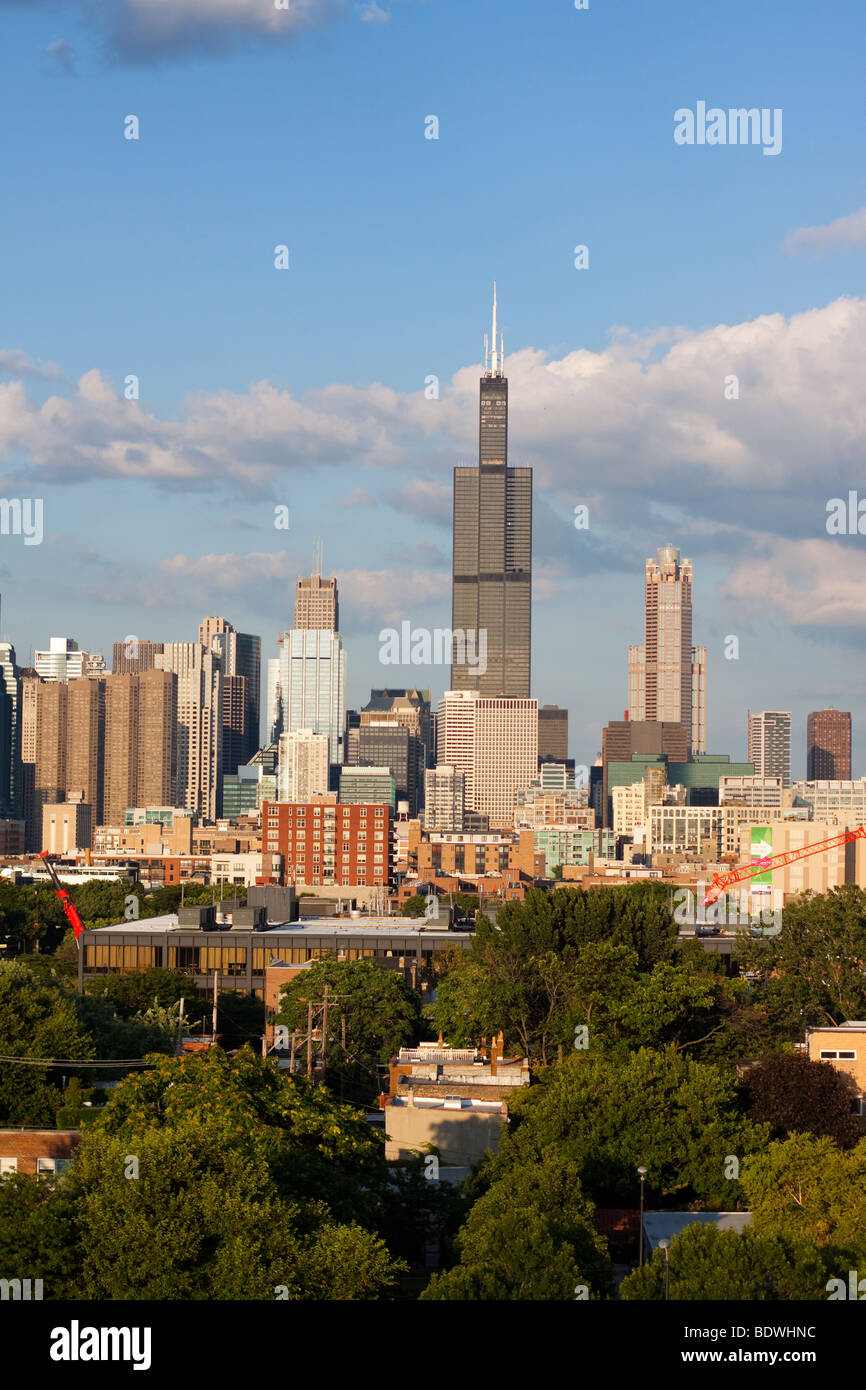 Pleasant summer afternoon clouds roll over the famous Chicago skyline, punctuated by the tall Willis Tower. Stock Photo